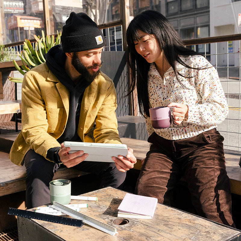 12oz-rise-mug-h8 12oz_rise_coffee_mug_dusty_orchid_couple_city_patio_square.jpg