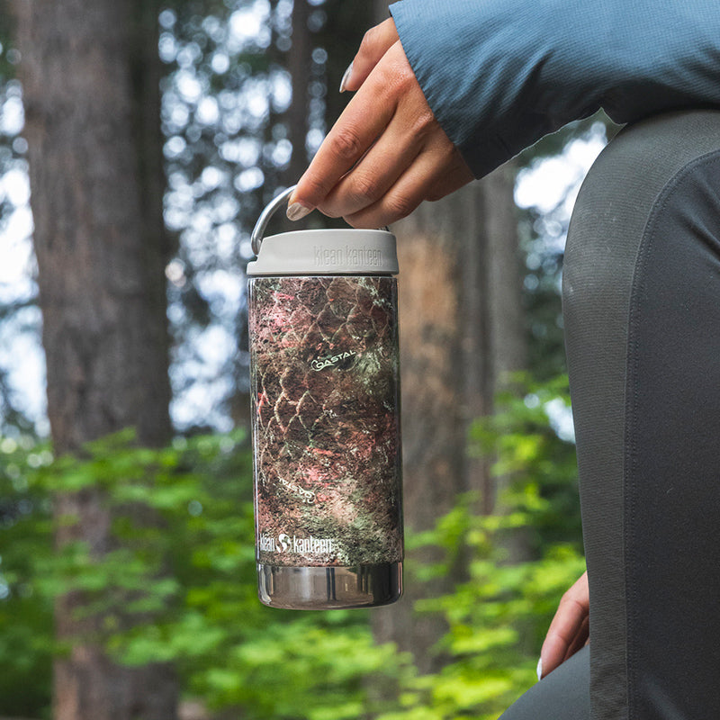 12oz-tkwide-with-cafe-cap-mossy-oak-p1 12oz_tumbler_mossyoak_rainbowtrout_hand_closeup_square.jpg
