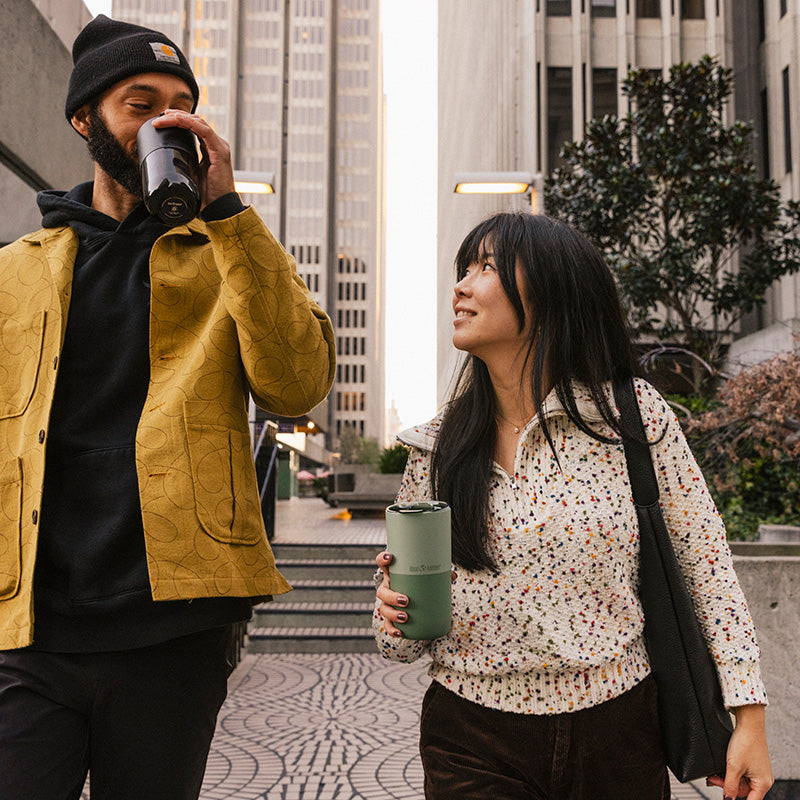 16oz-rise-tumbler-o6 16oz_rise_tumbler_black_iceberg_couple_drink_city_street_square.jpg