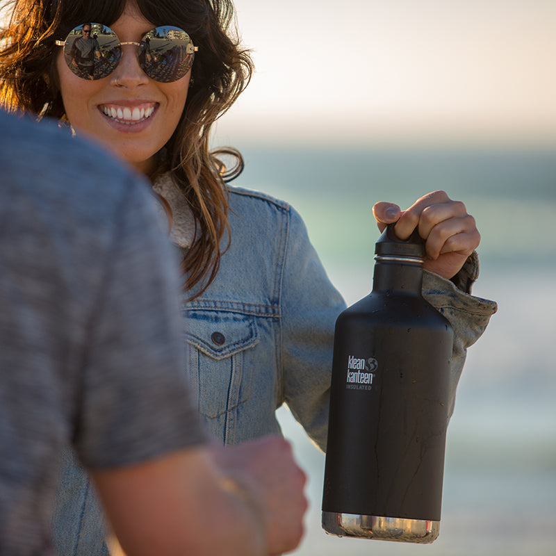 64oz-classic-with-loop-cap-h4 64oz_insulated_classic_black_beach_girl_hand_square.jpg