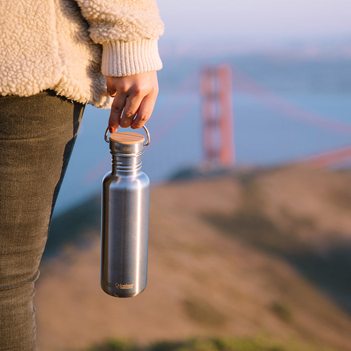 27oz-reflect-with-bamboo-cap-j1 K27SSLRF-BS-BAMBOO_reflect_bottle_bridge_lifestyle.jpg